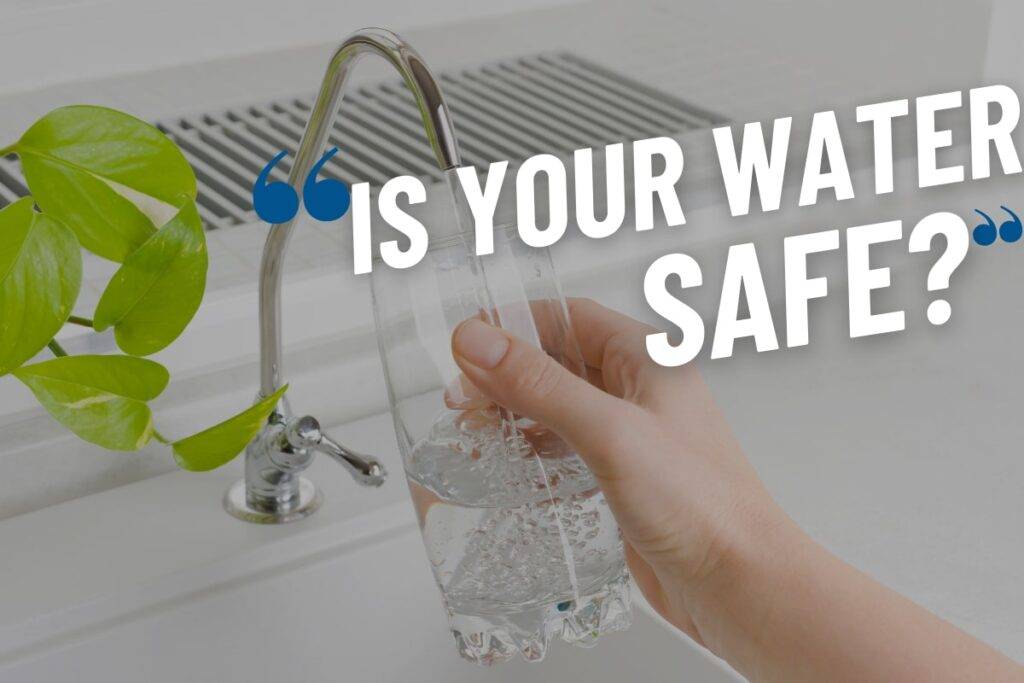 Person filling a glass of water with tested filtered water