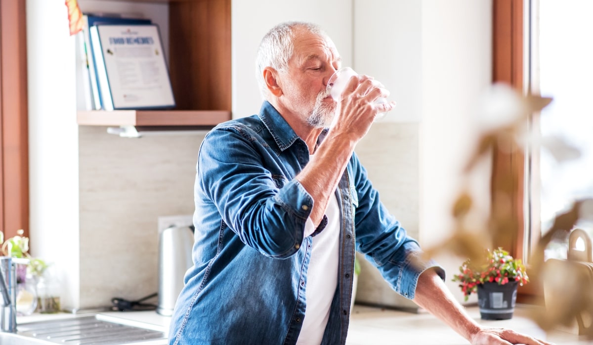 An old man drinking healthy soft water